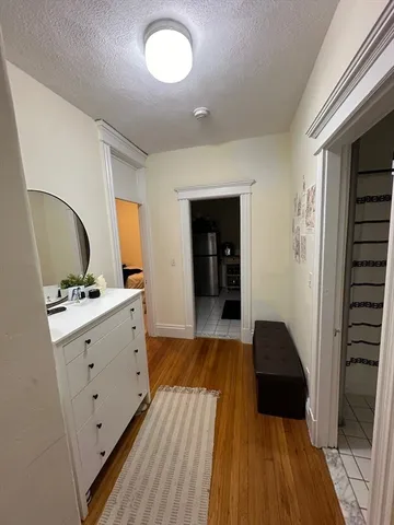 a view of hallway with wooden floor