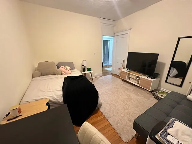 a bedroom with furniture and a flat screen tv