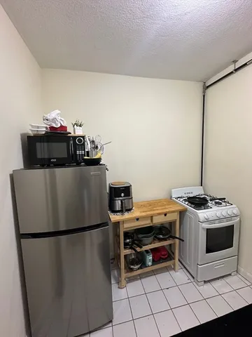 a kitchen with a stove and a refrigerator