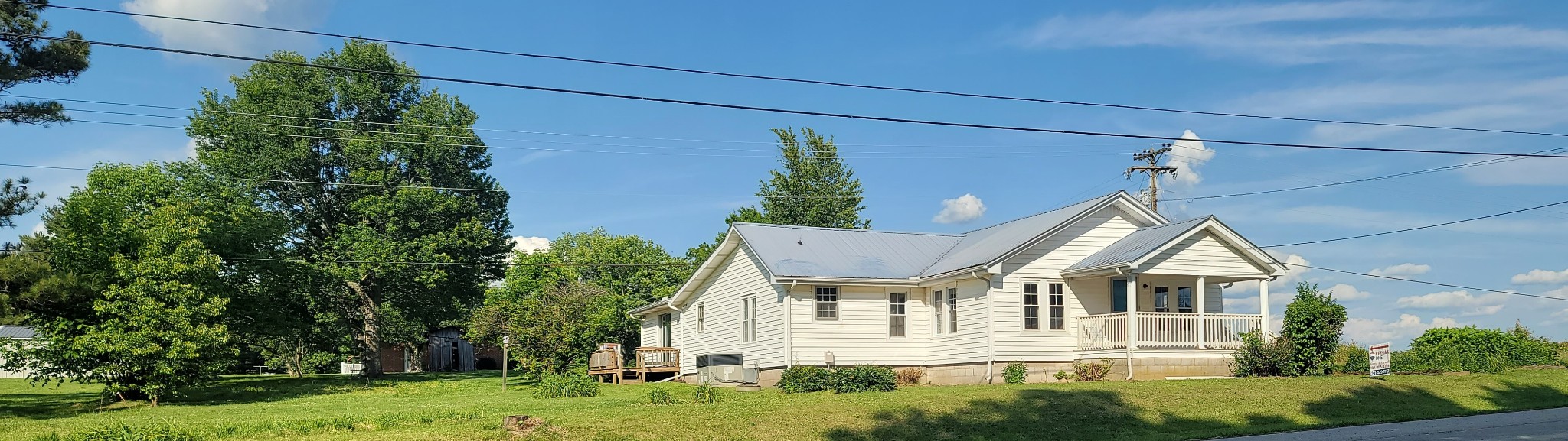 19 Turkey Scratch Road Spencer, TN 38585 - Photo 2 of 27 a white house with a yard and plants