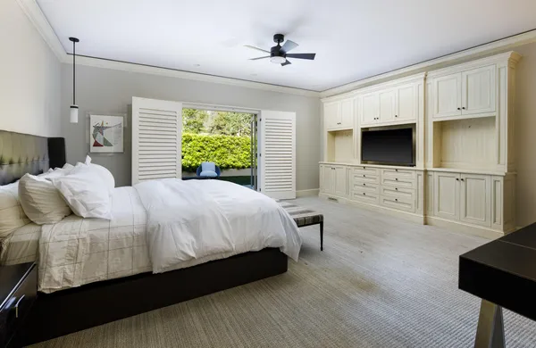 a bed room with a bed window and a chair