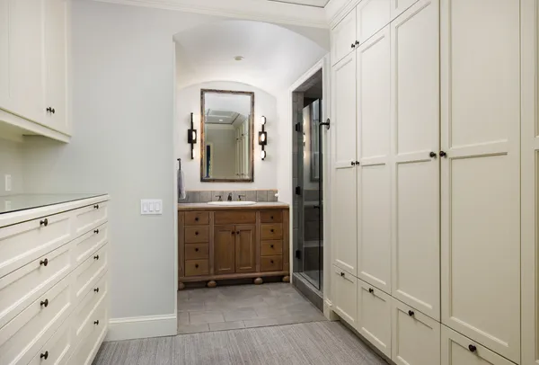 a spacious bathroom with a double vanity sink a mirror and a bathtub