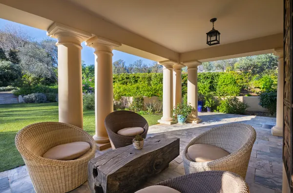 a living room with furniture and a floor to ceiling window