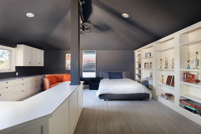 a bedroom with furniture and a book shelf