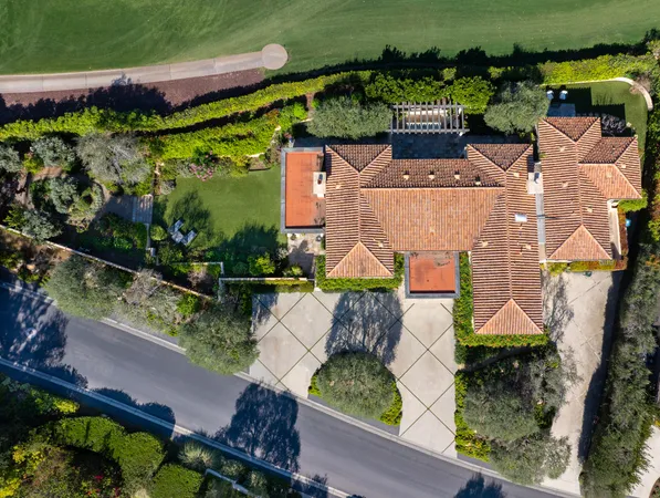 an aerial view of a house with a garden and swimming pool