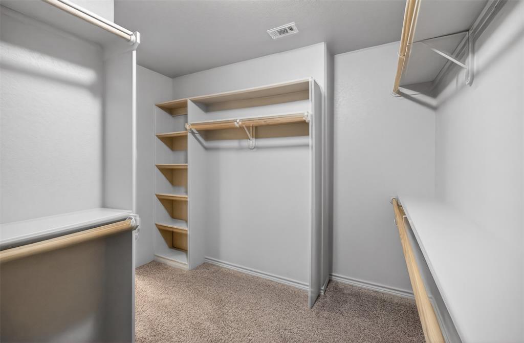 505 East 5th Street Springtown, TX 76082 - Photo 21 of 39 a view of walk in closet with empty racks