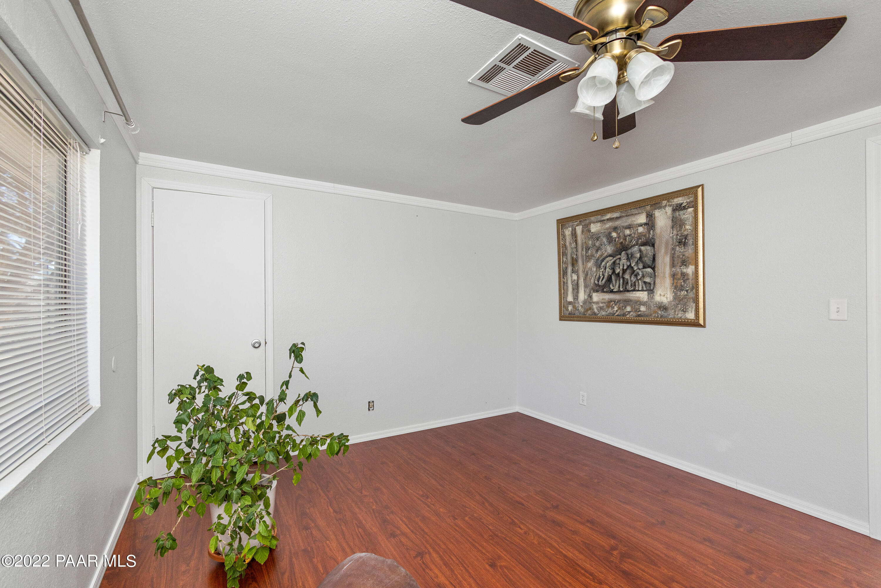 463 Antelope Run Road Paulden, AZ 86334 - Photo 14 of 26 a bedroom with a bed chandelier and a window