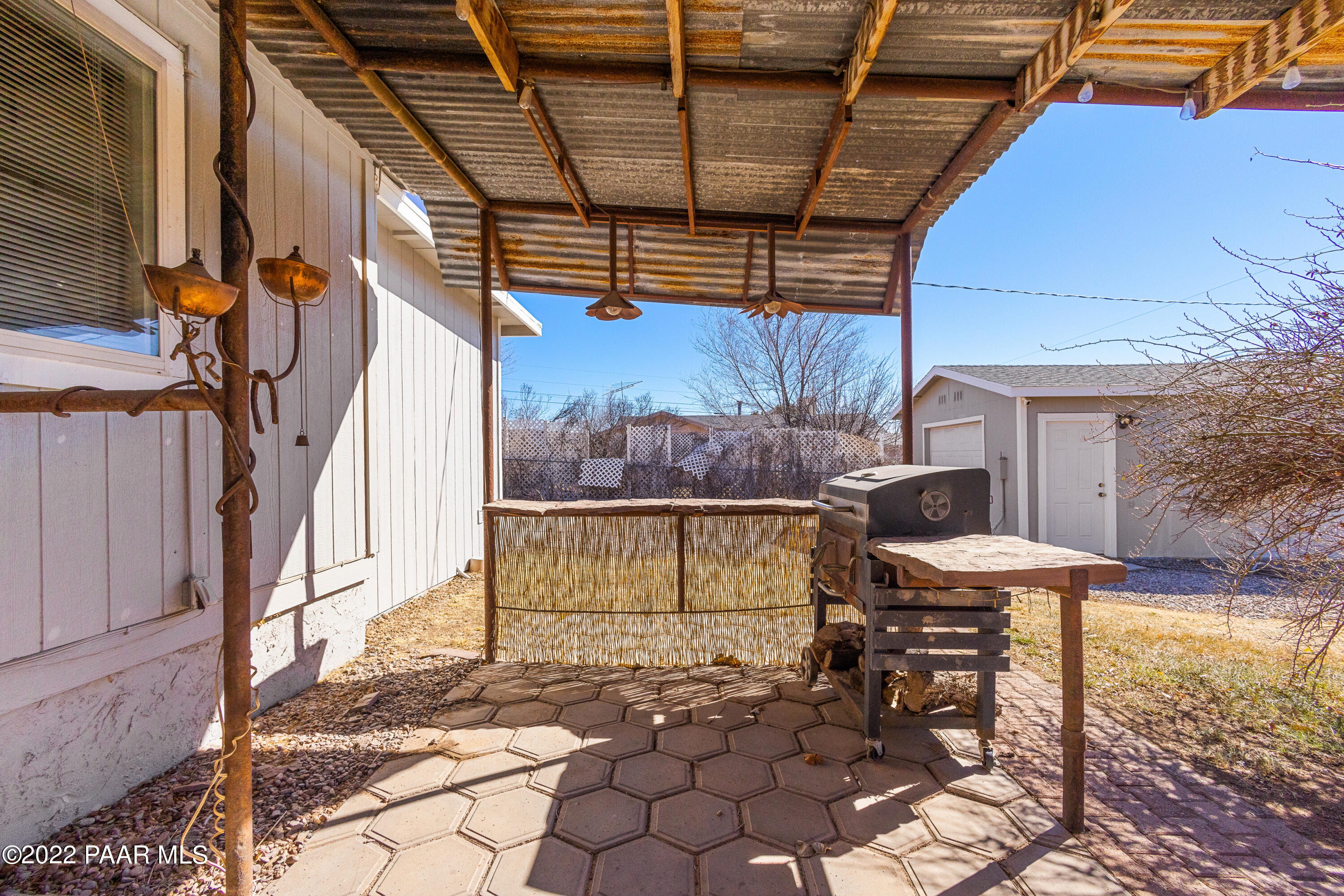 463 Antelope Run Road Paulden, AZ 86334 - Photo 23 of 26 a view of a patio with table and chairs with wooden floor and plants