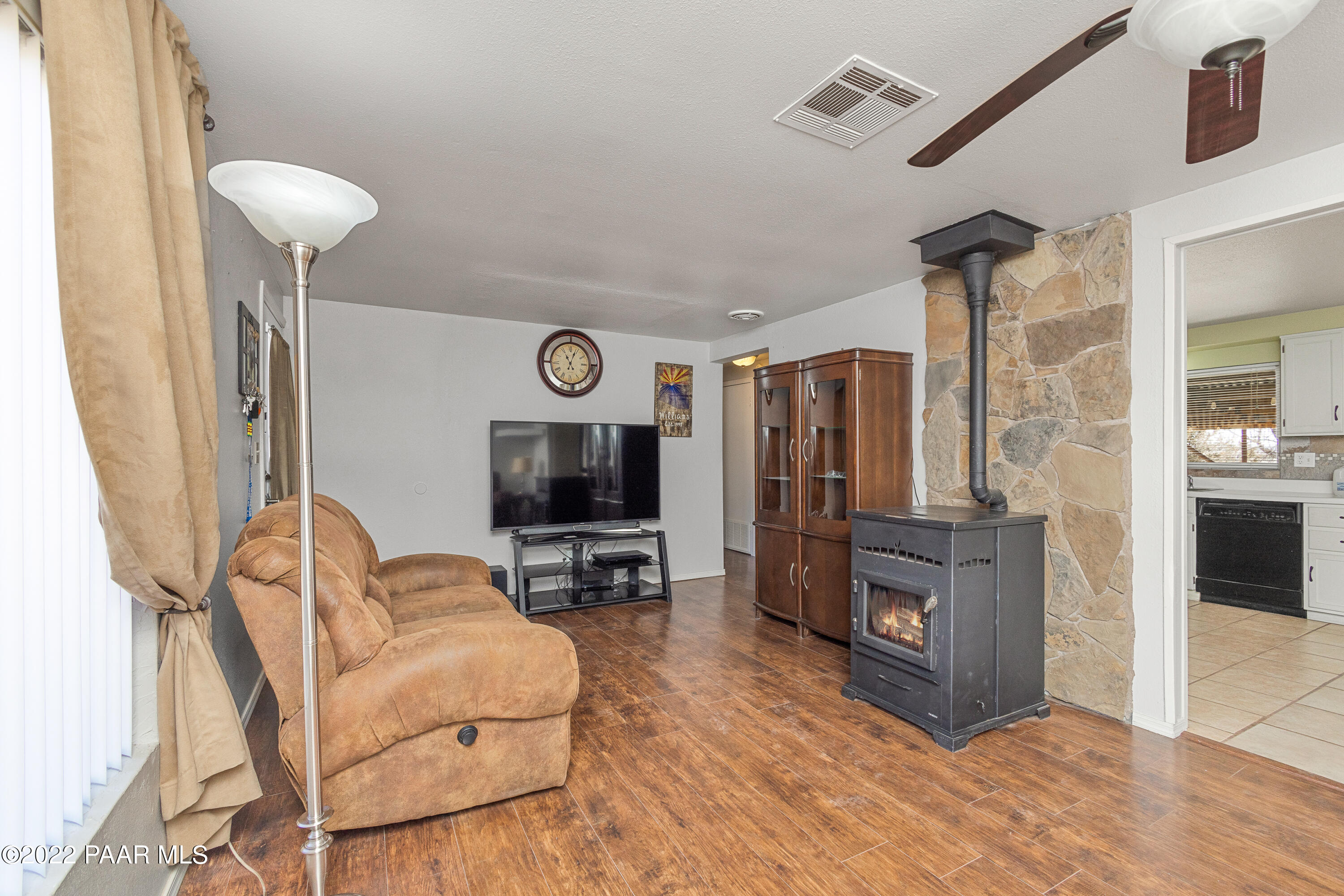 463 Antelope Run Road Paulden, AZ 86334 - Photo 7 of 26 a living room with furniture a flat screen tv and a refrigerator