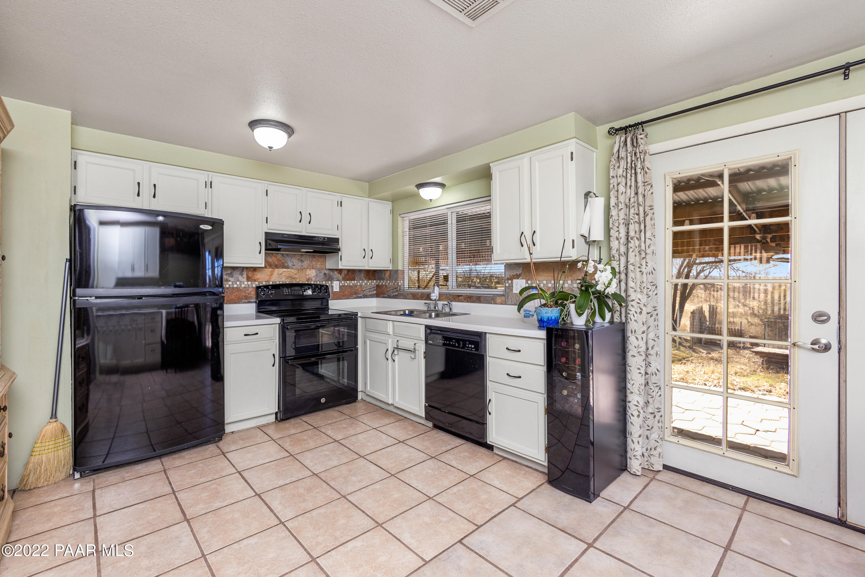 463 Antelope Run Road Paulden, AZ 86334 - Photo 10 of 26 a kitchen with a refrigerator a stove top oven and kitchen island