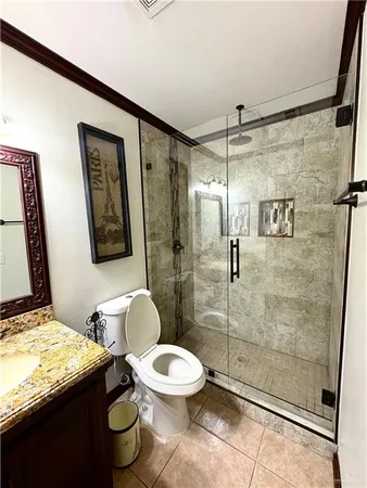 a bathroom with a granite countertop toilet sink and shower