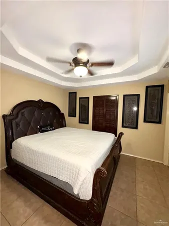 a bedroom with a large bed and a large window