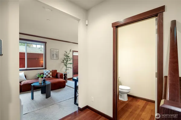 a view of a room with furniture and wooden floor