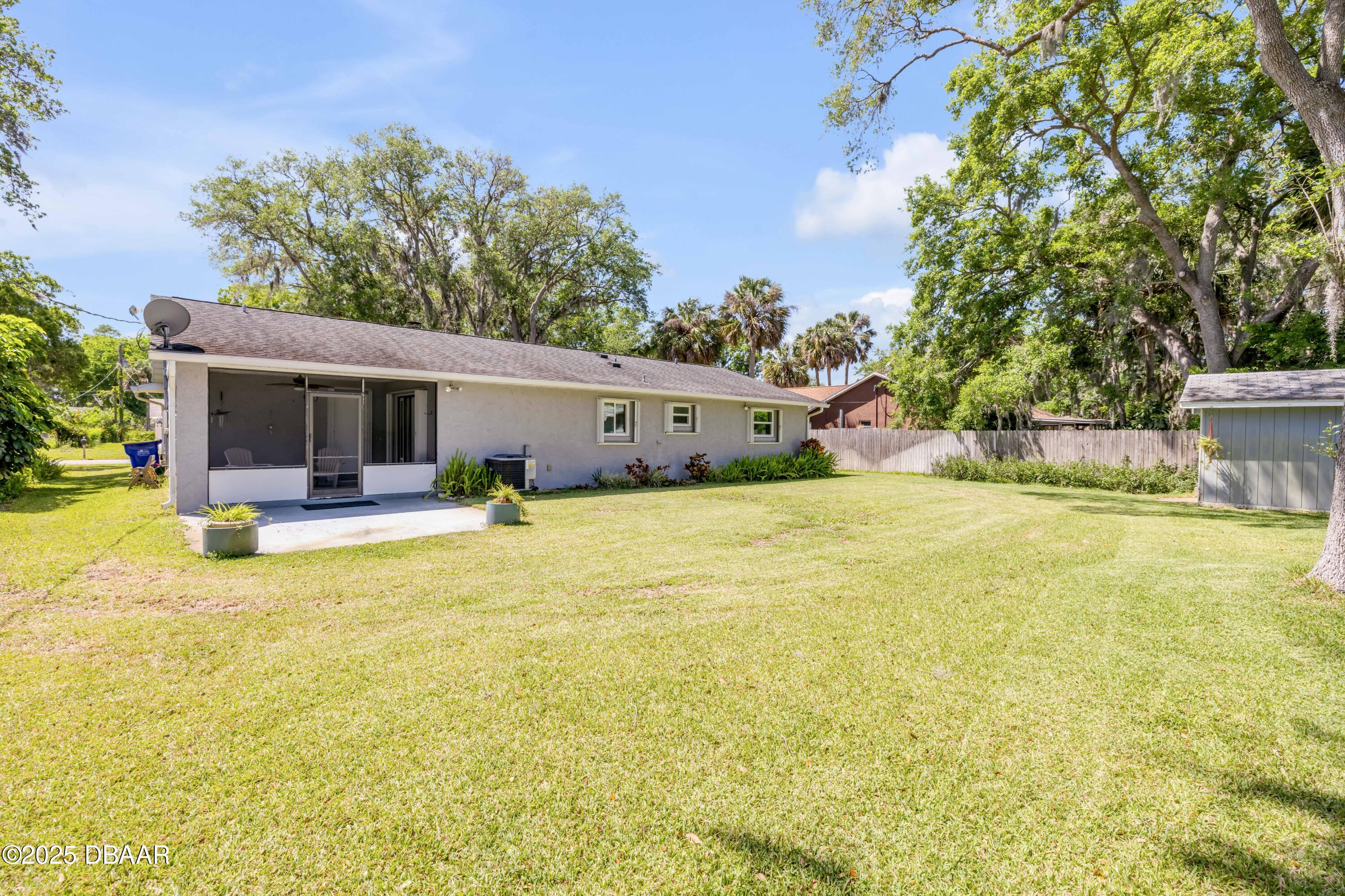 1851 Pine Tree Drive Edgewater, FL 32141 - Photo 18 of 29 a swimming pool with outdoor seating and yard