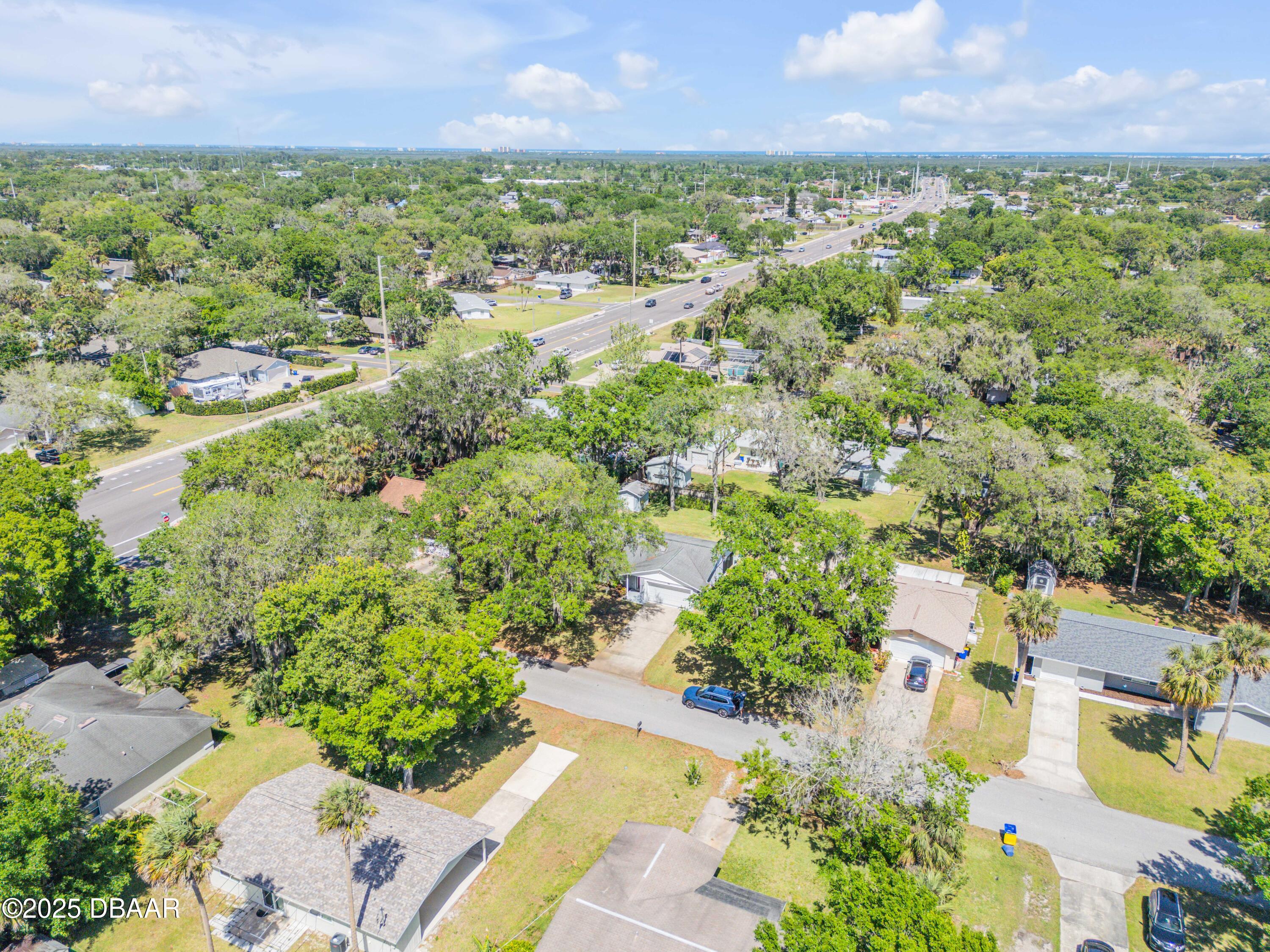 1851 Pine Tree Drive Edgewater, FL 32141 - Photo 22 of 29 an aerial view of residential houses with outdoor space and trees all around