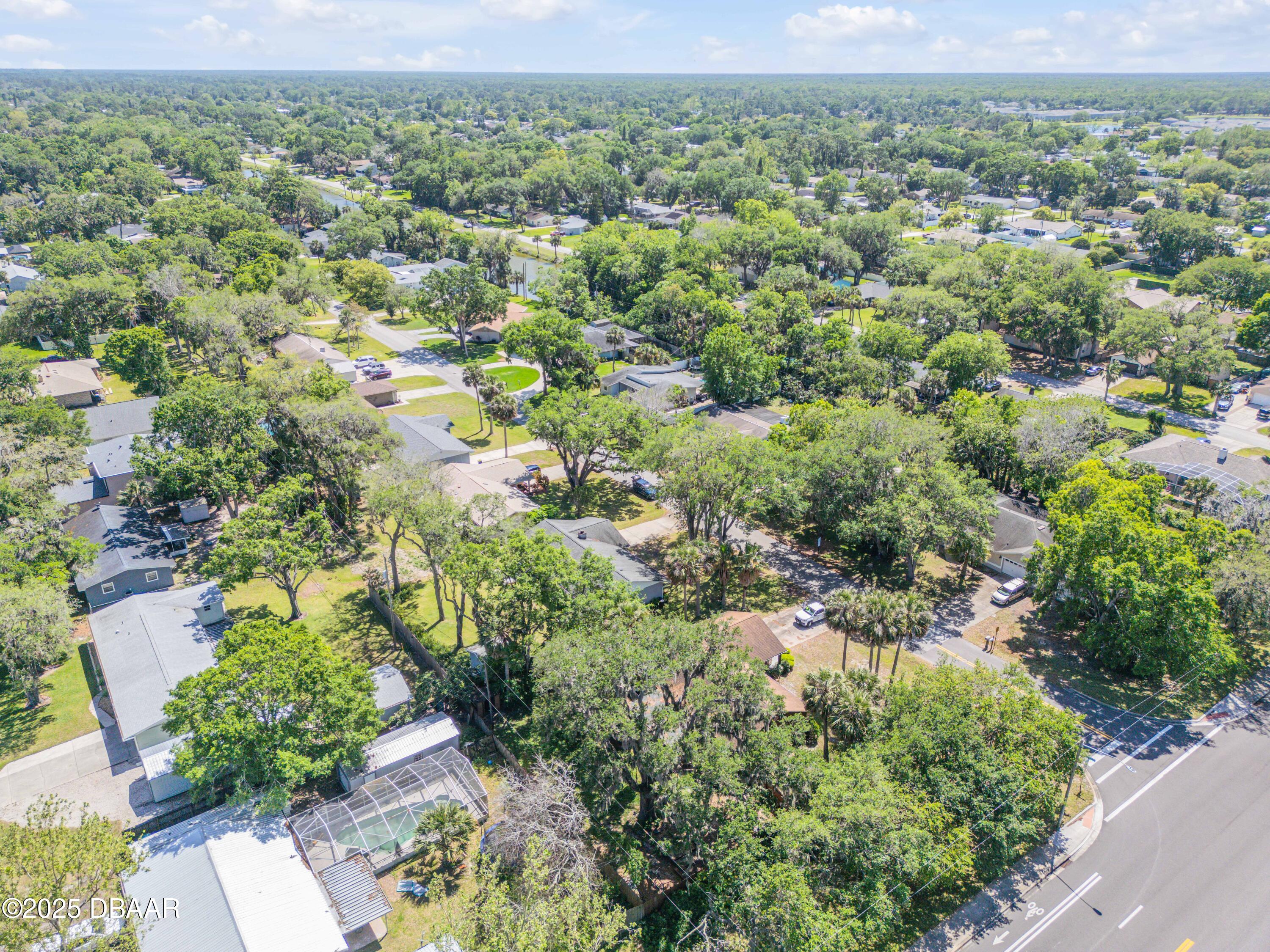 1851 Pine Tree Drive Edgewater, FL 32141 - Photo 23 of 29 an aerial view of a houses with a yard and lake