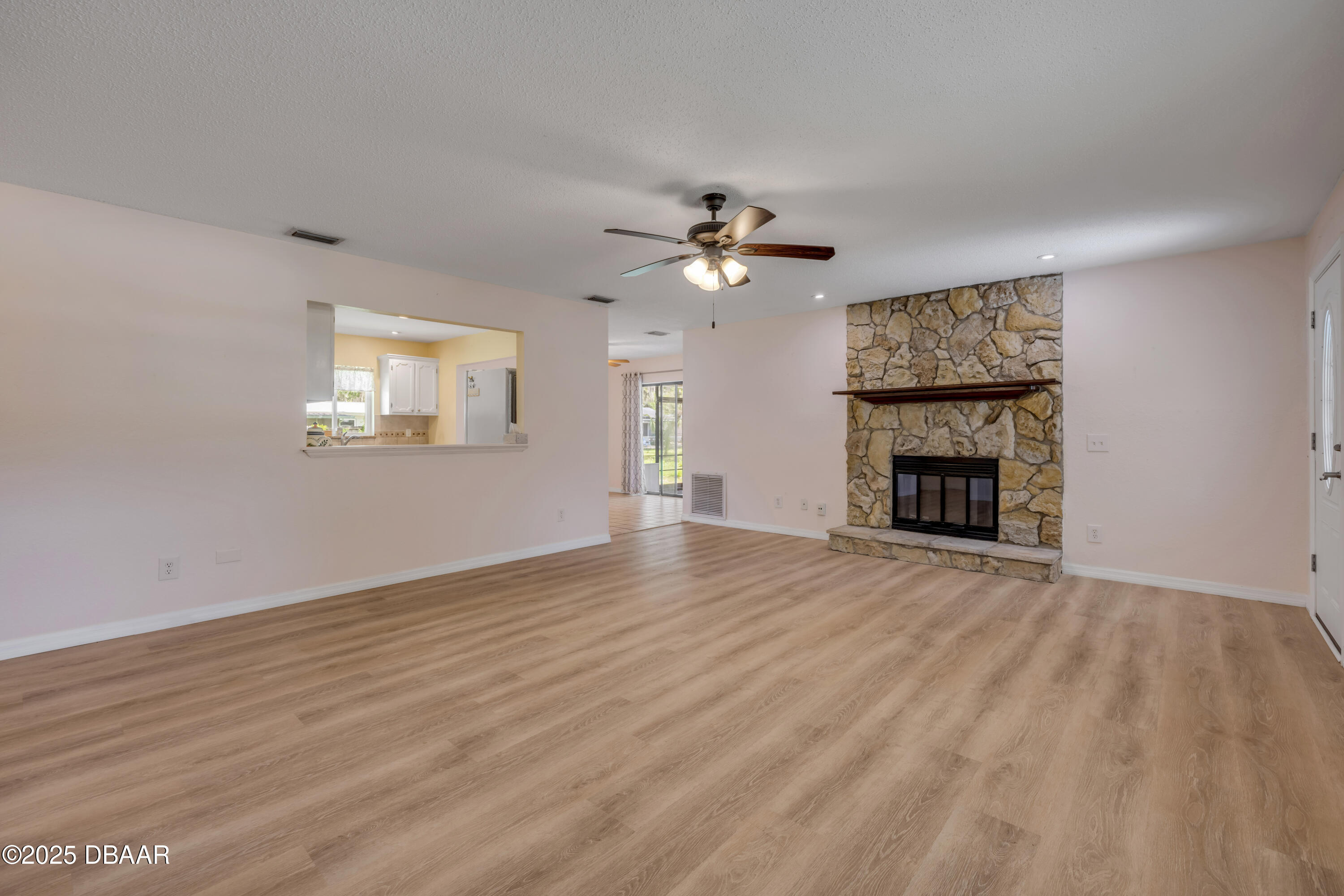 1851 Pine Tree Drive Edgewater, FL 32141 - Photo 5 of 29 an empty room with windows and fireplace