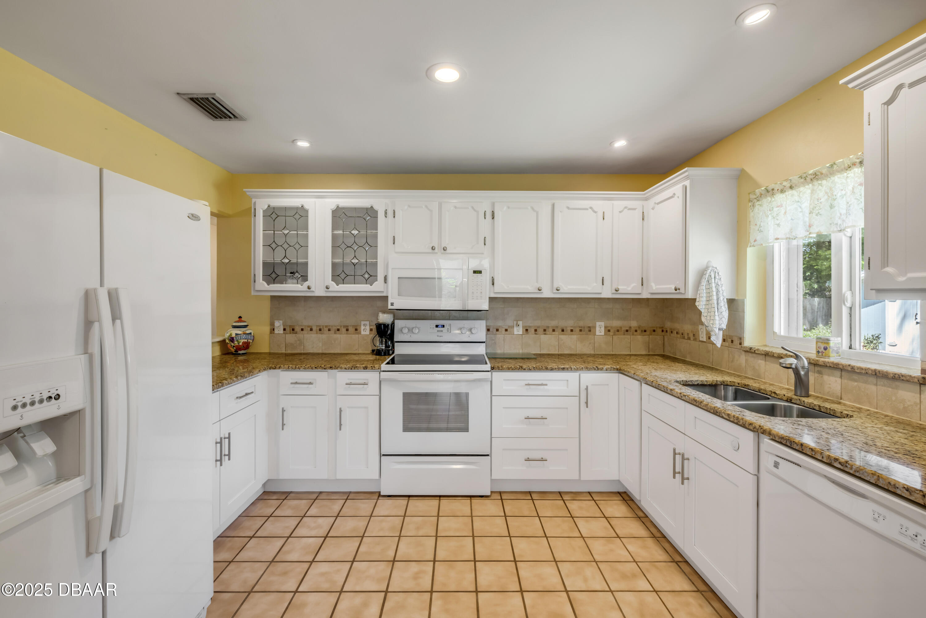 1851 Pine Tree Drive Edgewater, FL 32141 - Photo 8 of 29 a kitchen with a refrigerator a sink and cabinets
