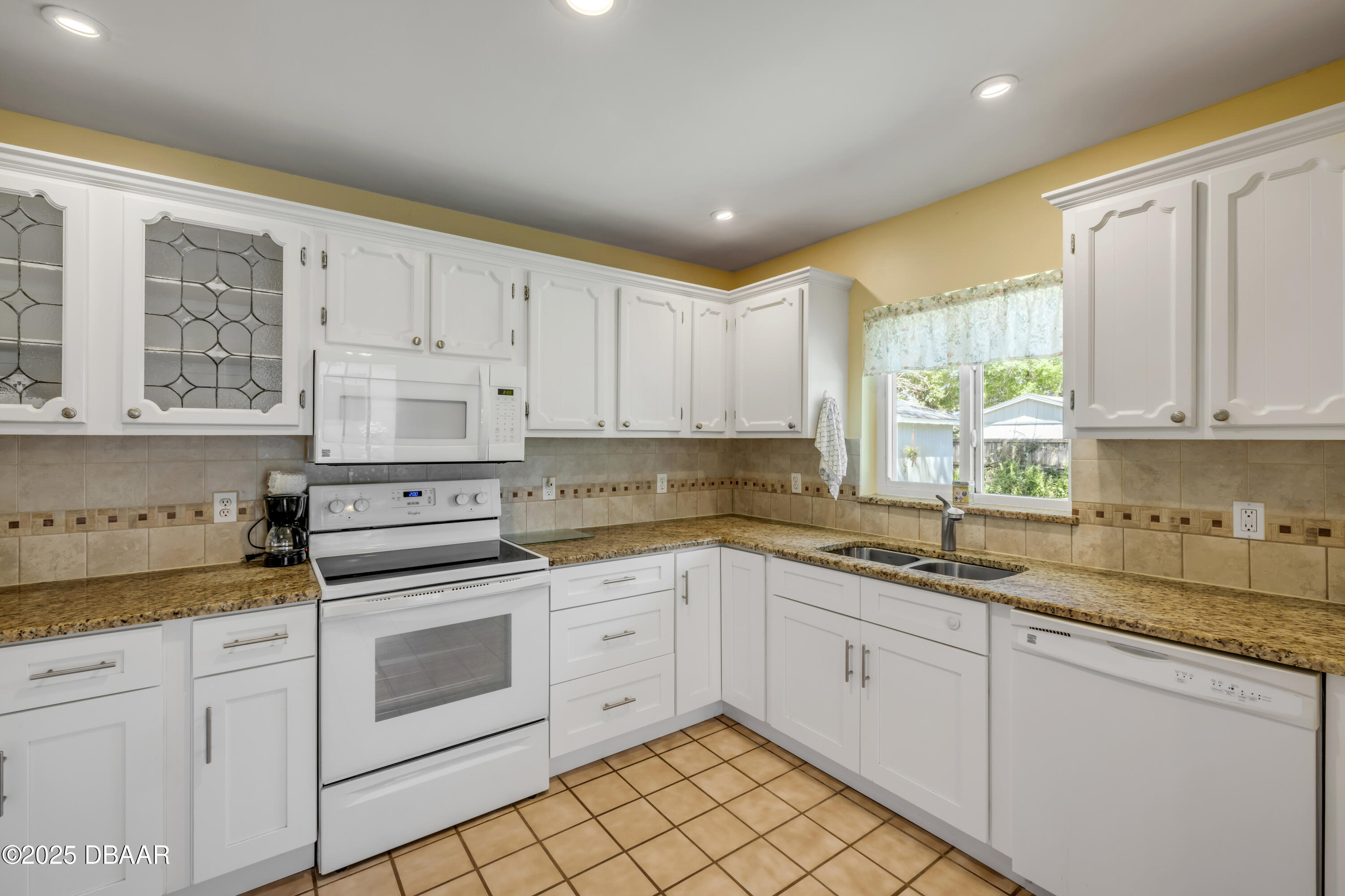 1851 Pine Tree Drive Edgewater, FL 32141 - Photo 10 of 29 a kitchen with white cabinets and white appliances