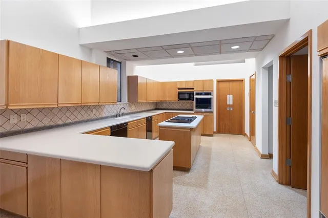 a room with lots of windows and chairs