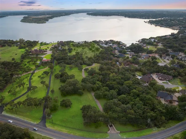 a house with green field in front of it