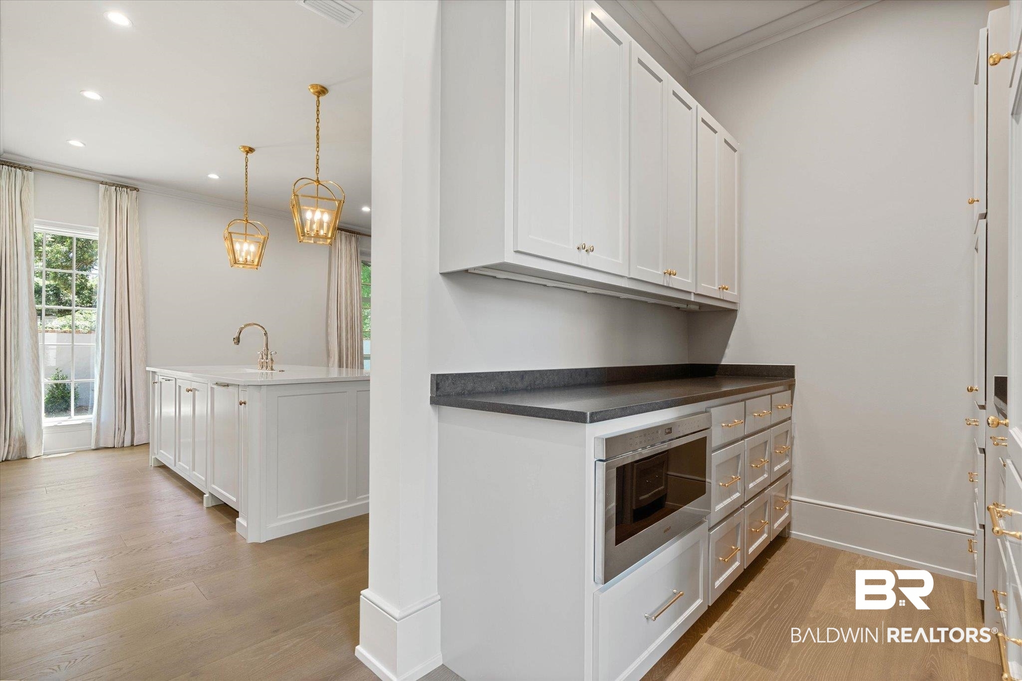 3 Canterbury Park Mobile, AL 36608 - Photo 8 of 43 Kitchen with ornamental molding, light wood finished floors, recessed lighting, dark countertops, and a sink