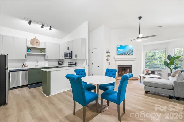 a kitchen with a dining table chairs stove and kitchen view