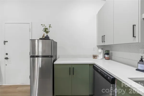 a kitchen with a refrigerator and cabinets