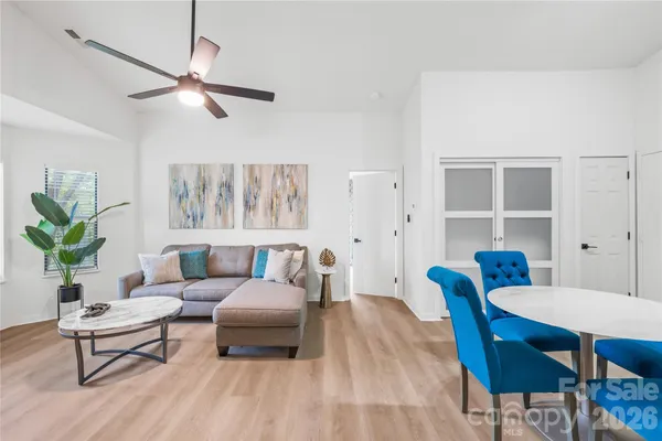 a living room with furniture and a wooden floor