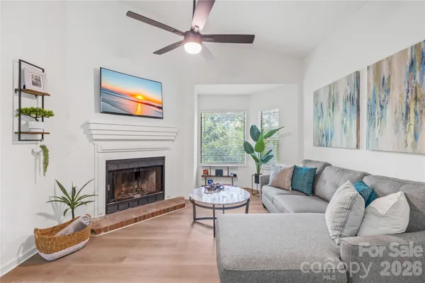 a living room with furniture and a fireplace