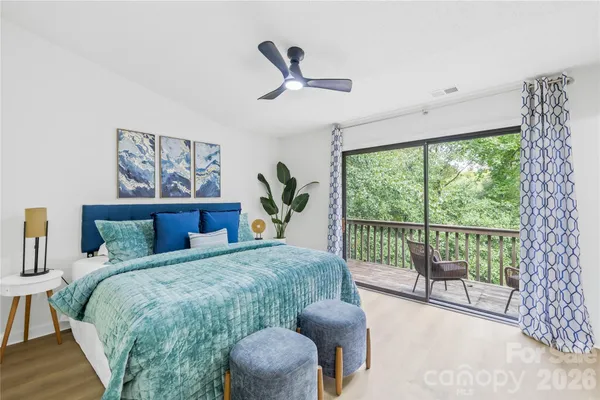 a bedroom with a bed and a large window