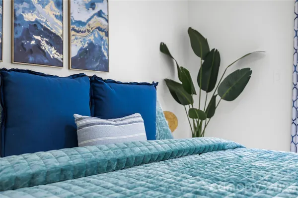 a bedroom with a bed and a painting on the wall