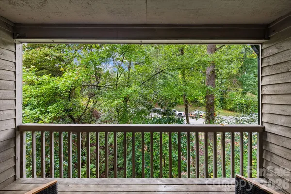 a view of balcony with deck and trees