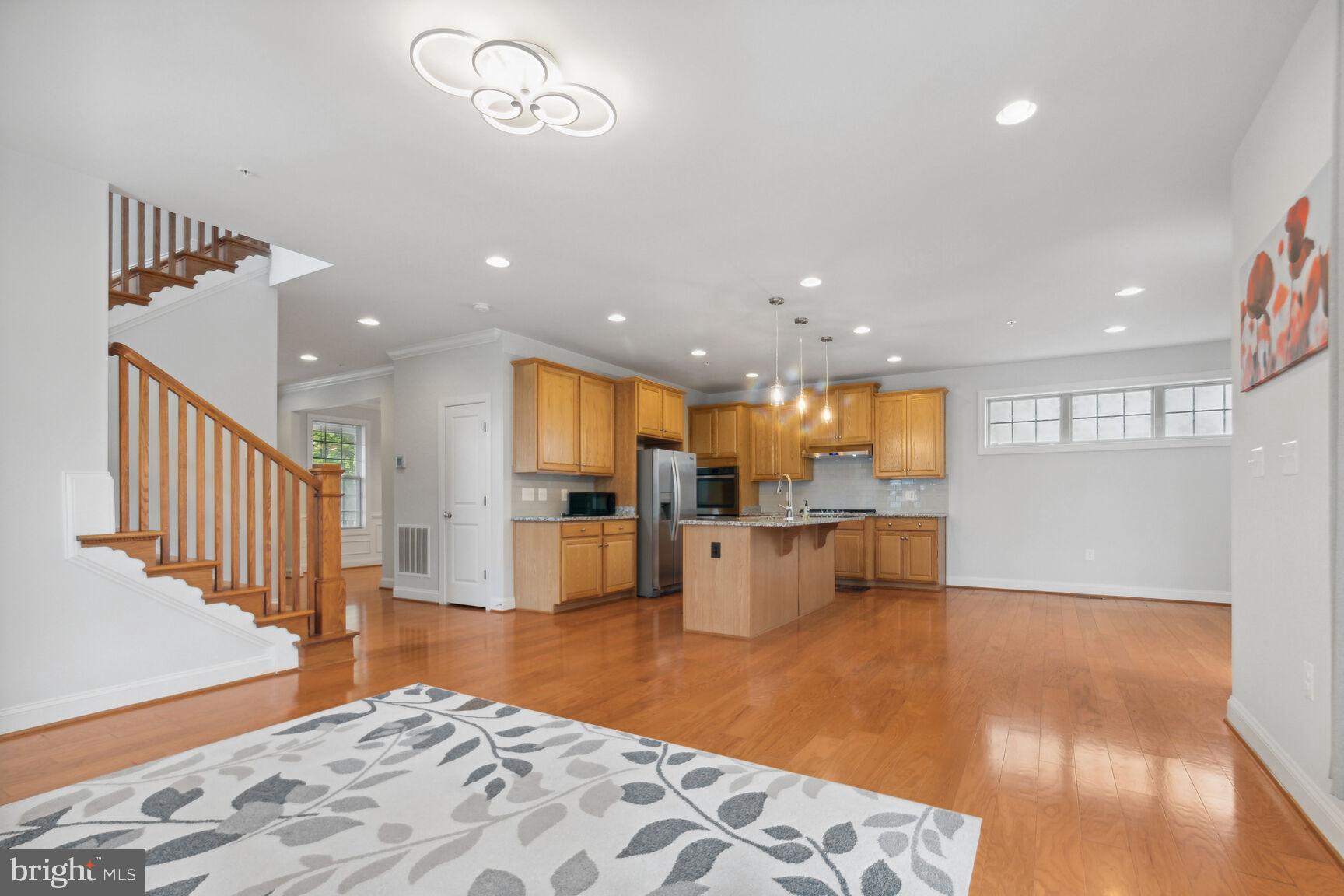 13601 Soaring Wing Lane Silver Spring, MD 20906 - Photo 12 of 53 a open kitchen with white cabinets and wooden floor