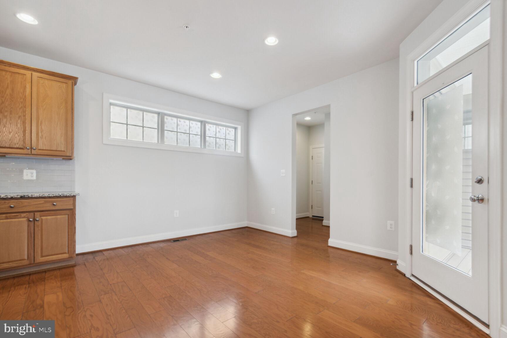 13601 Soaring Wing Lane Silver Spring, MD 20906 - Photo 13 of 53 a view of an empty room with wooden floor and a window