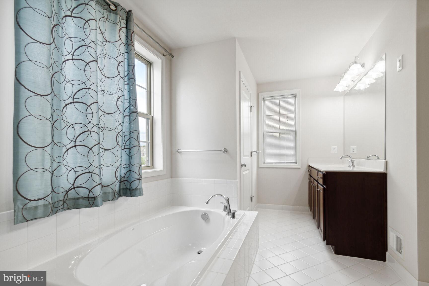 13601 Soaring Wing Lane Silver Spring, MD 20906 - Photo 30 of 53 a bathroom with a bathtub and a sink