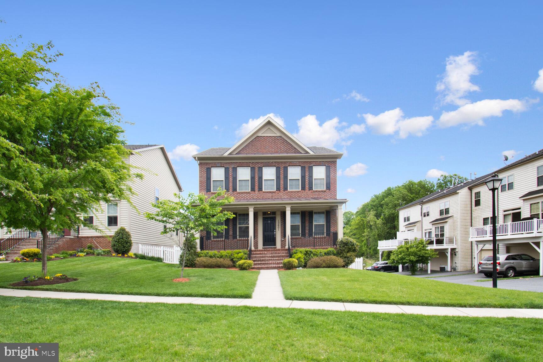 13601 Soaring Wing Lane Silver Spring, MD 20906 - Photo 3 of 53 a front view of a house with a yard table and chairs