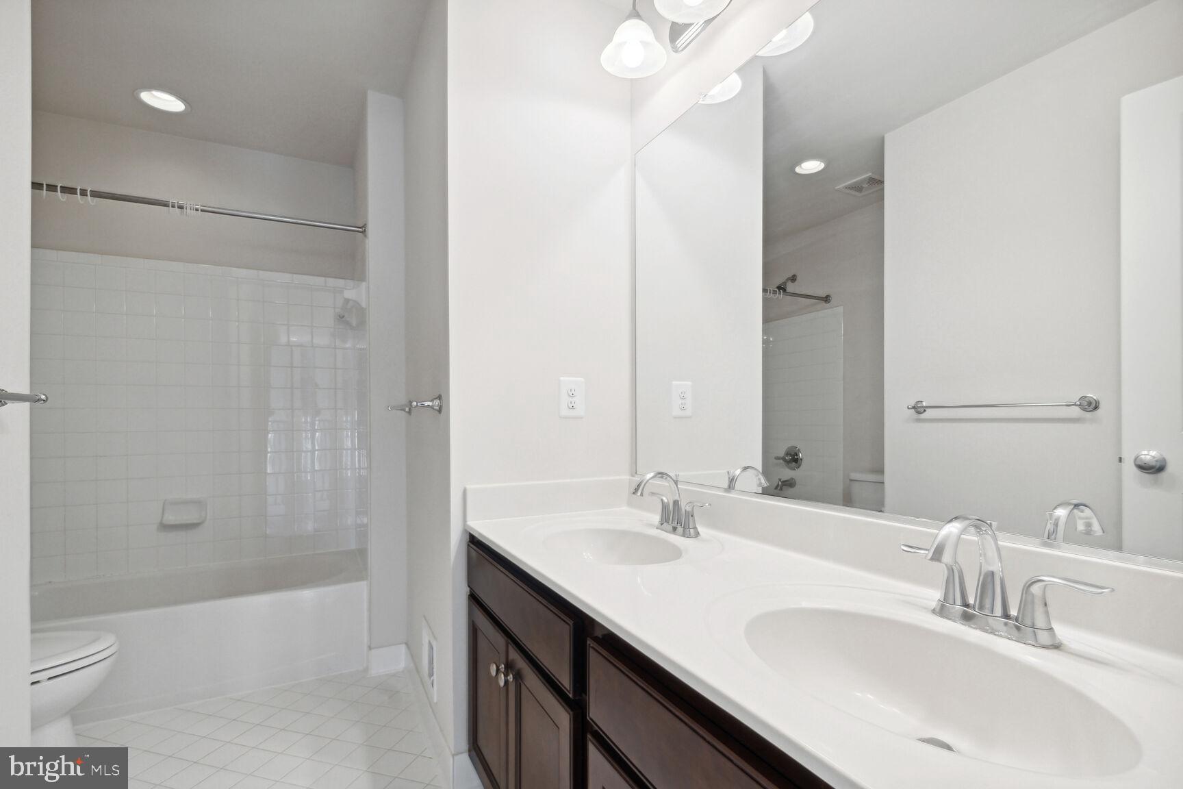 13601 Soaring Wing Lane Silver Spring, MD 20906 - Photo 32 of 53 a bathroom with a sink double vanity granite tub and shower