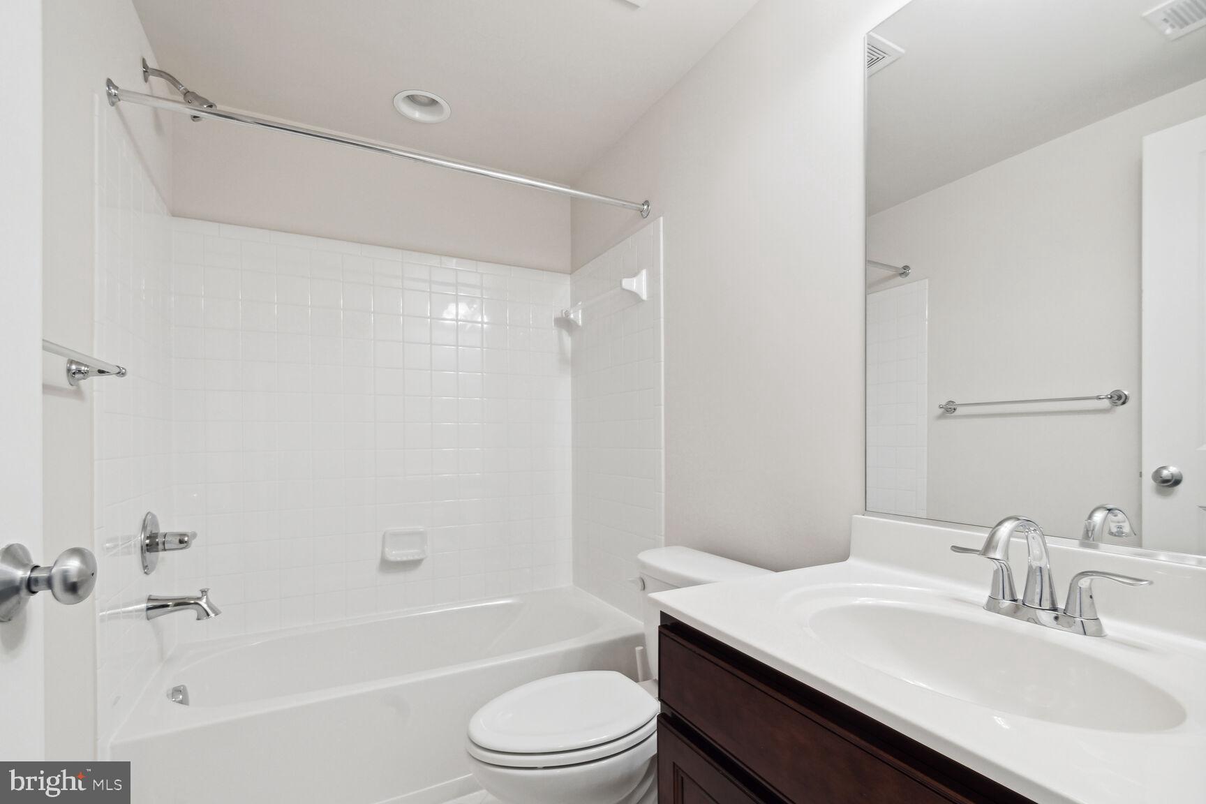 13601 Soaring Wing Lane Silver Spring, MD 20906 - Photo 38 of 53 a bathroom with a sink a toilet and a bathtub