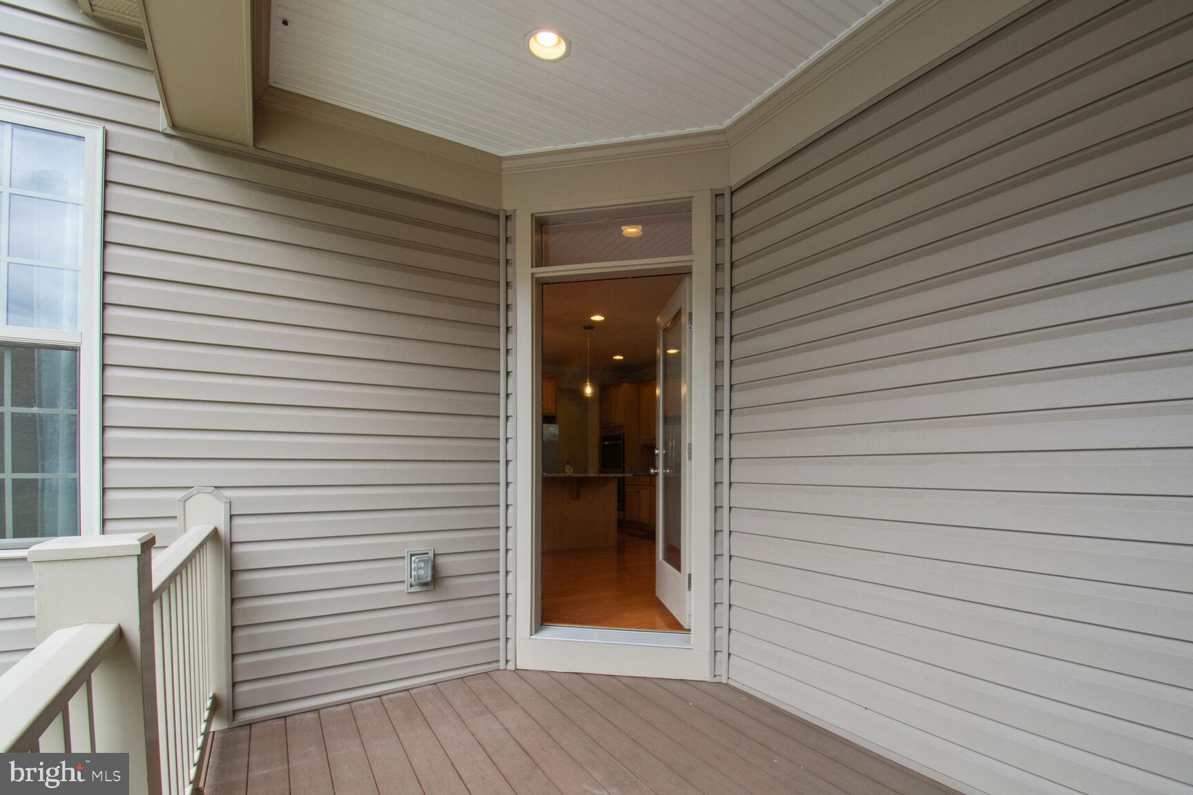 13601 Soaring Wing Lane Silver Spring, MD 20906 - Photo 40 of 53 a view of a porch with a door and wooden floor
