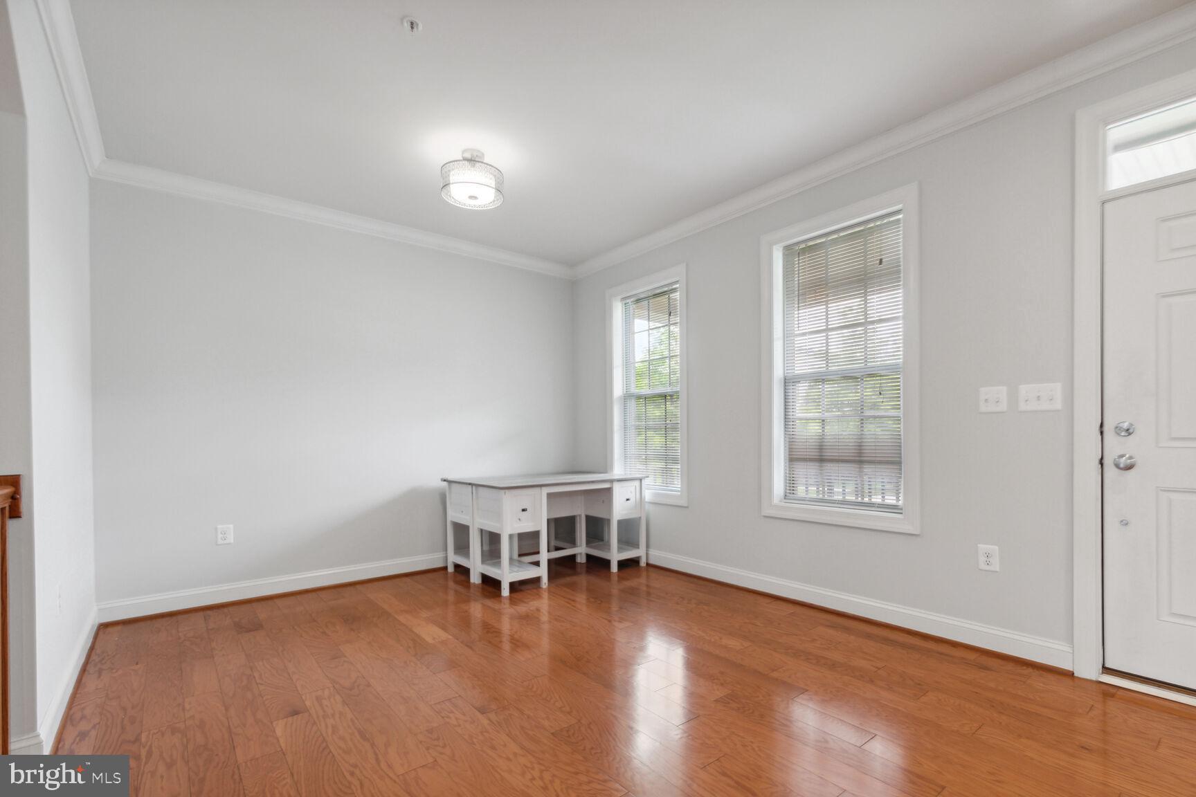 13601 Soaring Wing Lane Silver Spring, MD 20906 - Photo 4 of 53 an empty room with wooden floor and windows