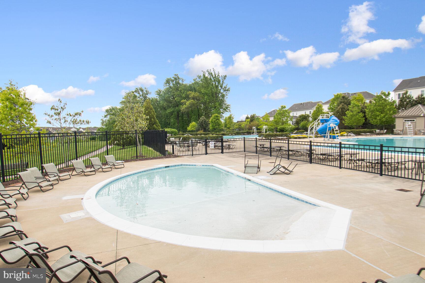 13601 Soaring Wing Lane Silver Spring, MD 20906 - Photo 47 of 53 a view of a swimming pool with a lounge chair