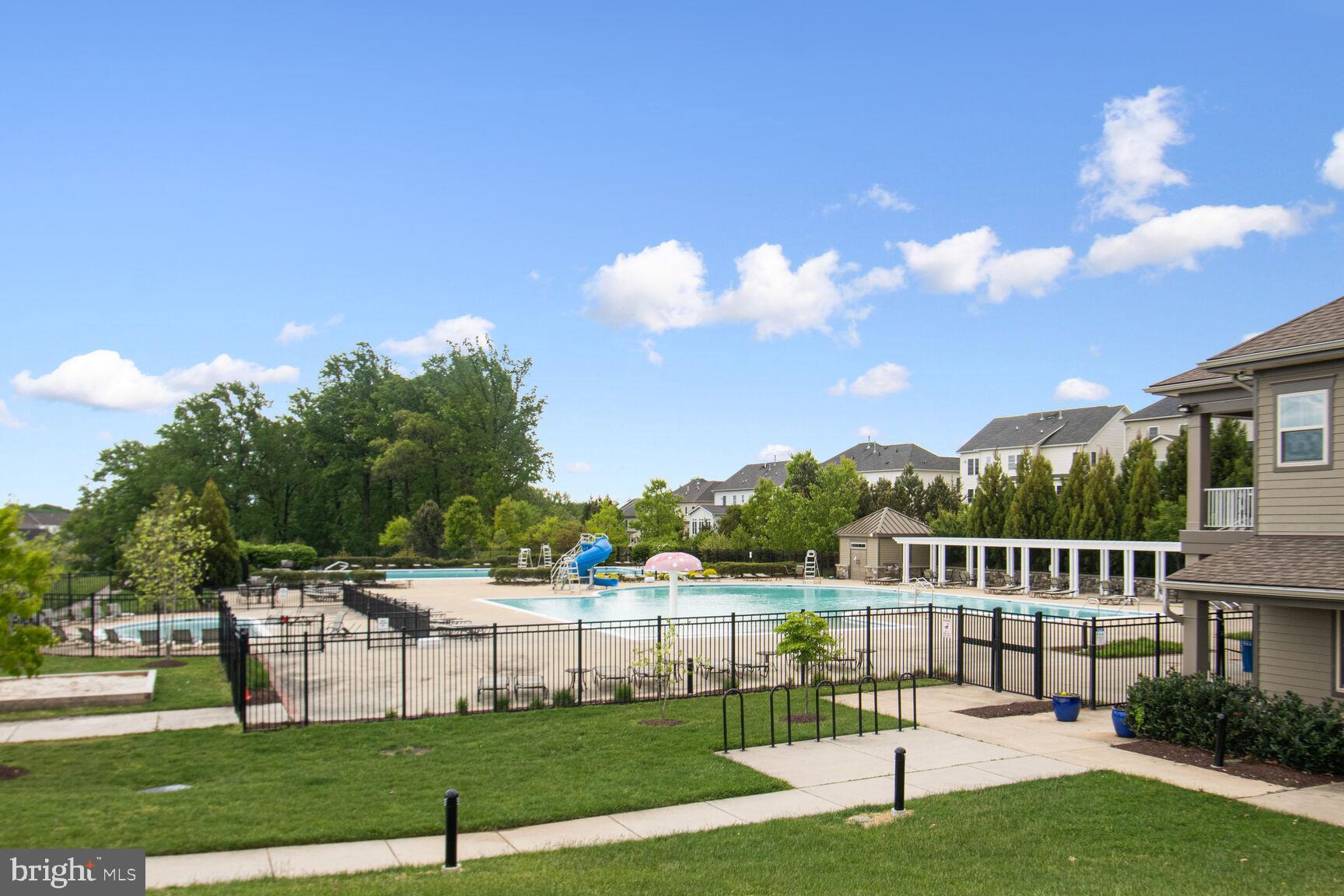 13601 Soaring Wing Lane Silver Spring, MD 20906 - Photo 50 of 53 a view of a white house with a big yard and plants