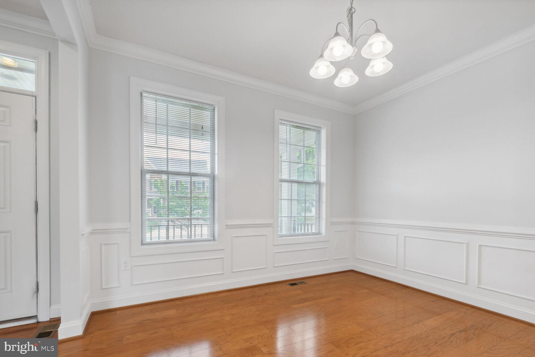 13601 Soaring Wing Lane Silver Spring, MD 20906 - Photo 7 of 53 an empty room with chandelier fan and windows