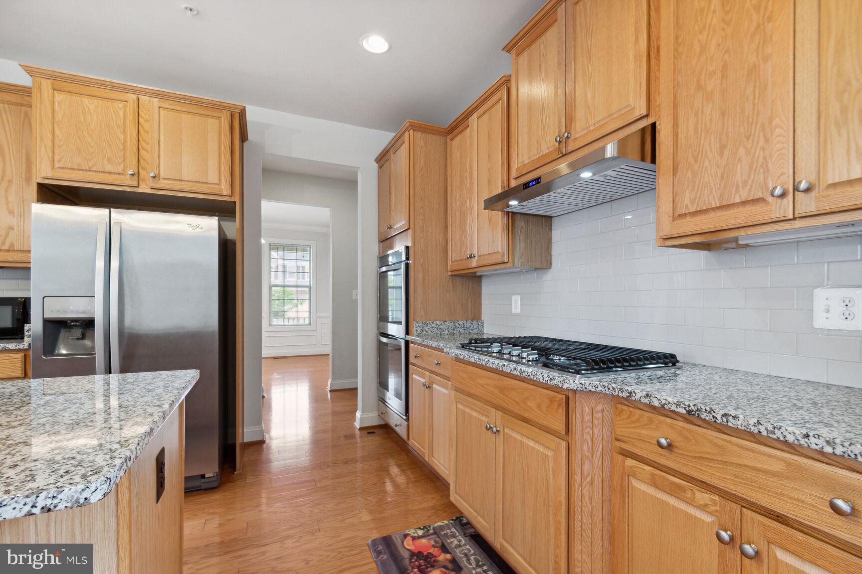 13601 Soaring Wing Lane Silver Spring, MD 20906 - Photo 9 of 53 a kitchen with stainless steel appliances granite countertop a stove a refrigerator and a cabinets