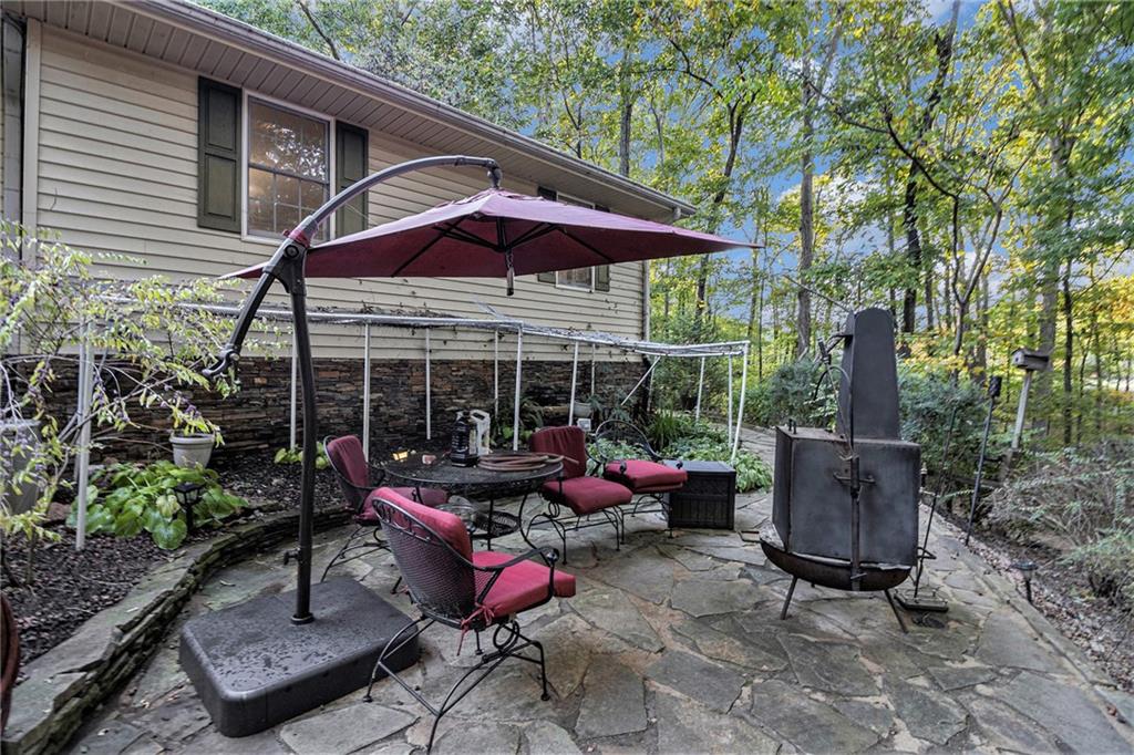 2170 Taylorsville Road Taylorsville, GA 30178 - Photo 35 of 48 an outdoor sitting area with furniture and umbrella