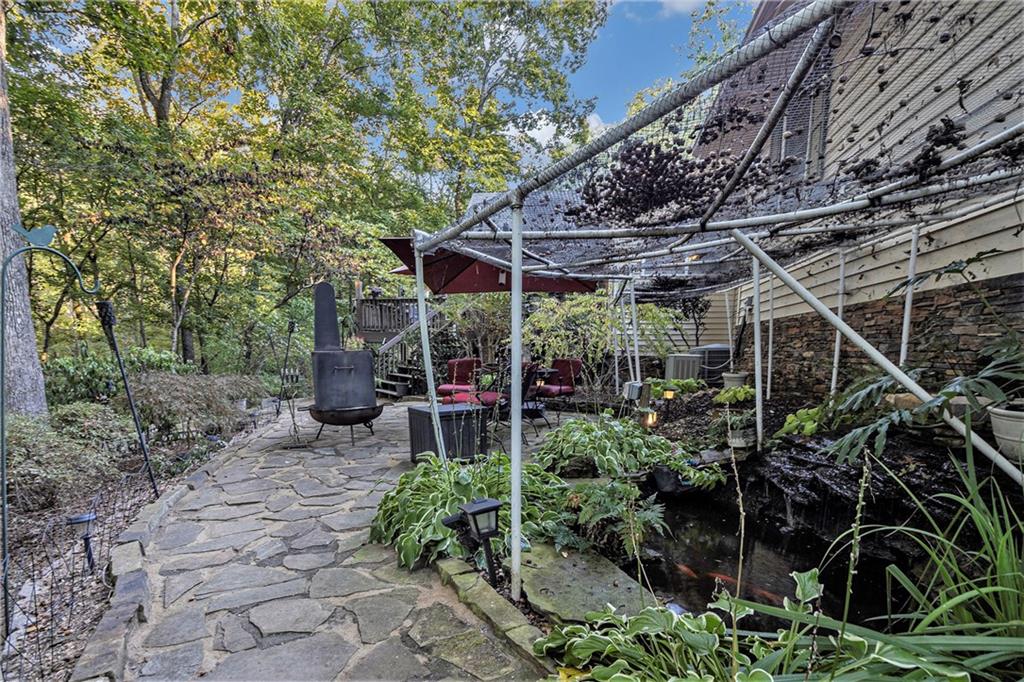 2170 Taylorsville Road Taylorsville, GA 30178 - Photo 36 of 48 a view of a patio with table and chairs under an umbrella