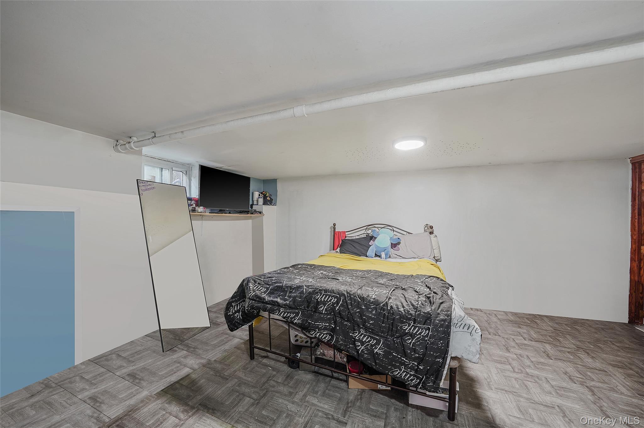 141 Branton Street Brooklyn, NY 11236 - Photo 13 of 20 a bedroom with a bed and a flat screen tv