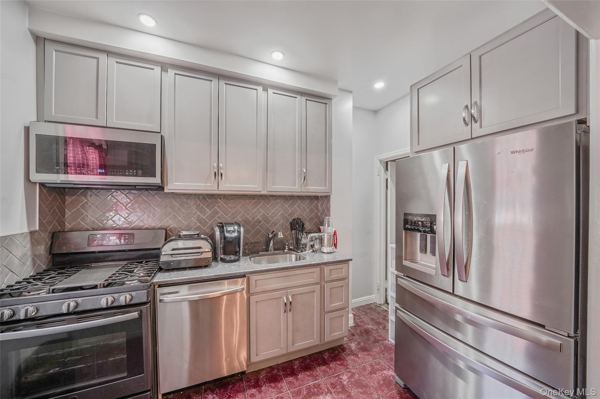 141 Branton Street Brooklyn, NY 11236 - Photo 7 of 20 a kitchen with stainless steel appliances a refrigerator stove and microwave