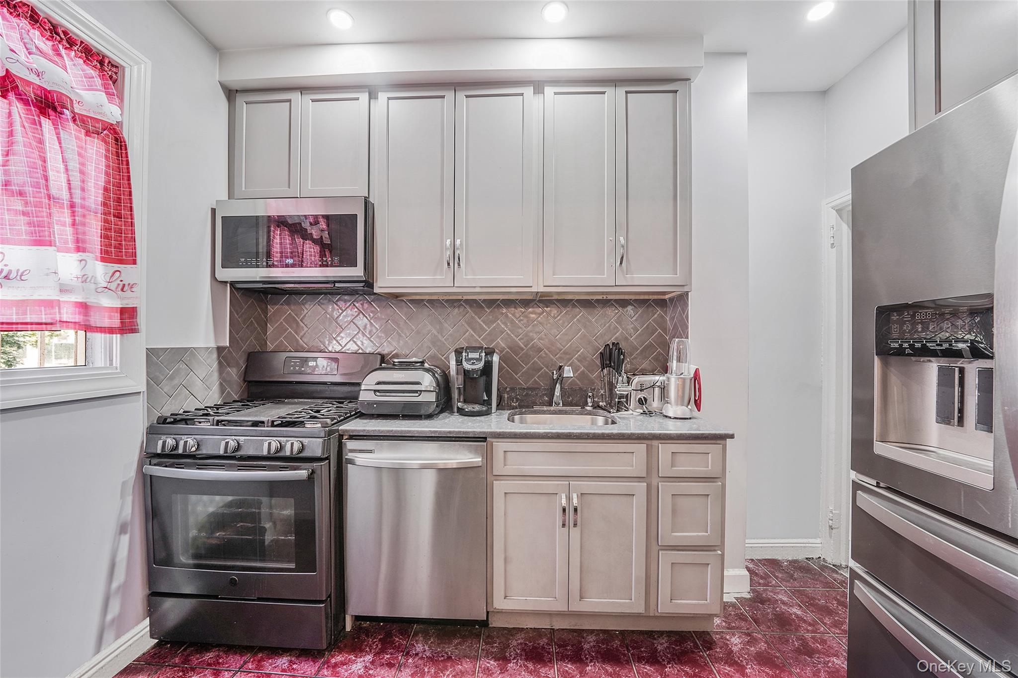 141 Branton Street Brooklyn, NY 11236 - Photo 8 of 20 a kitchen with stainless steel appliances granite countertop a stove and a refrigerator